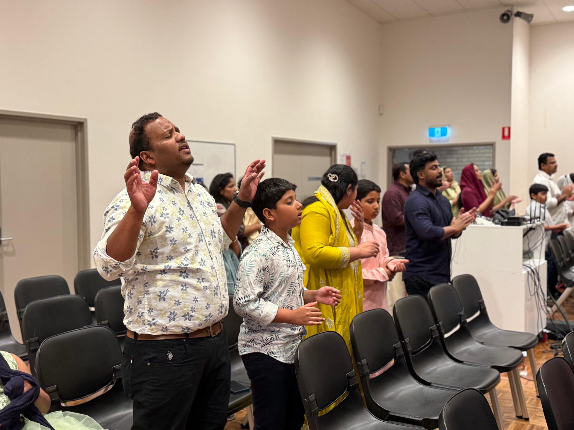 Family worshipping during a WPF service