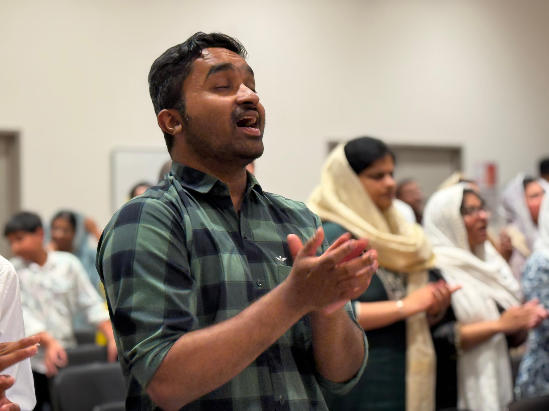 Man singing in worship during a service